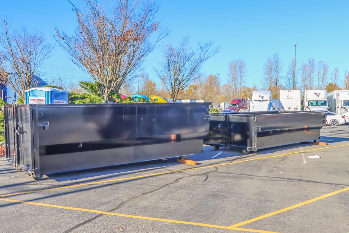 Professional dumpster rental service with roll-off container on residential driveway in Mount Washington